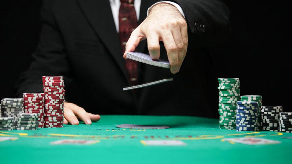 Man shuffling cards at poker table
