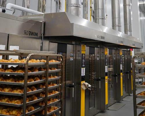 Stainless steel ovens and portable racks filled with baked rolls