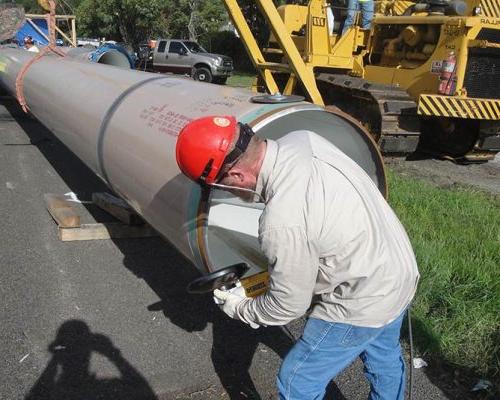 Man inspecting pipe